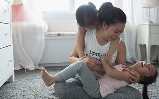 Two girls playing with mom